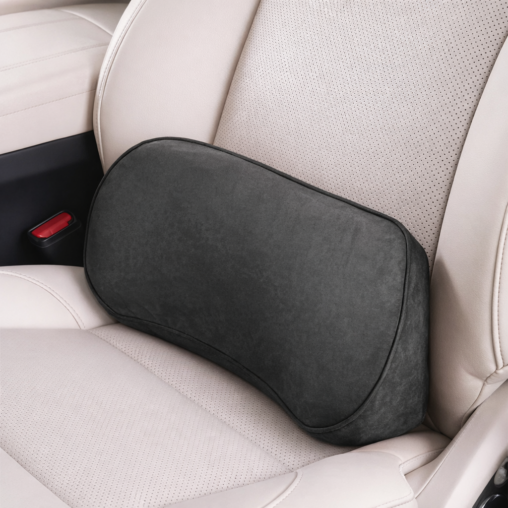 Black lumbar support pillow on beige car seat for ergonomic back comfort